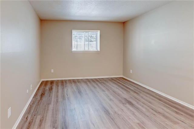 4157 Roanoke Rd Unit 2, Kansas City, MO 64111 - empty room with light wood-type flooring, baseboards, and a textured ceiling