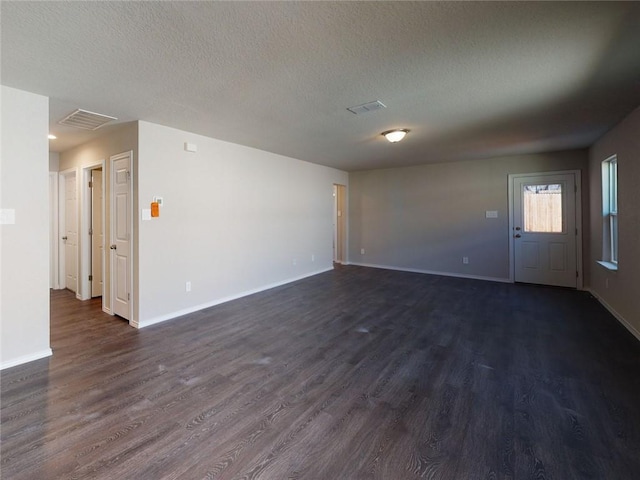 567 W Fountain St, Gardner, KS 66030 - spare room featuring dark wood-style floors, baseboards, and a textured ceiling