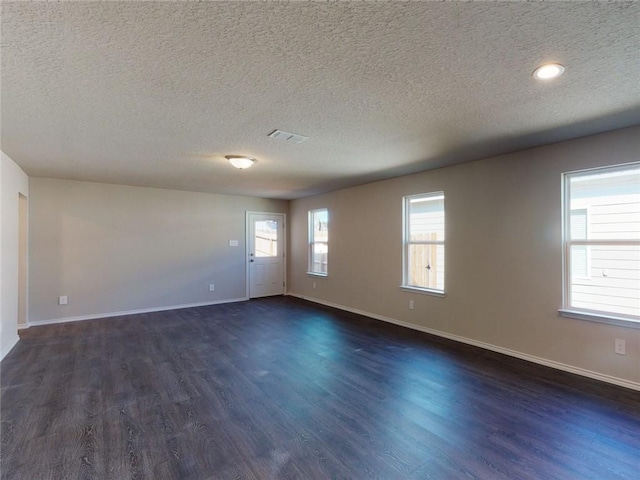 567 W Fountain St, Gardner, KS 66030 - spare room featuring dark wood-type flooring, a textured ceiling, and baseboards