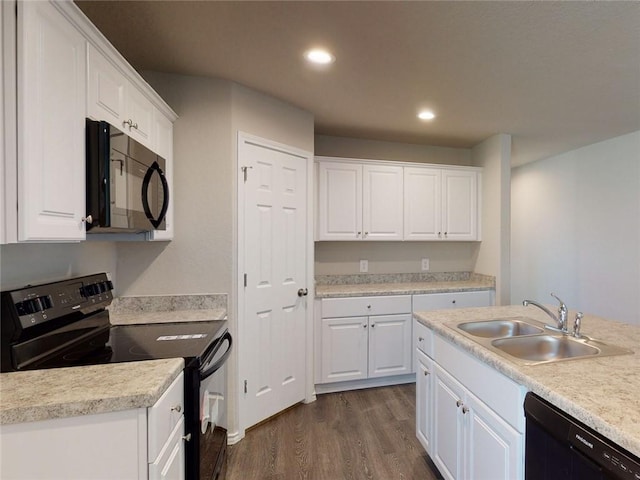 567 W Fountain St, Gardner, KS 66030 - kitchen with black appliances, a sink, dark wood finished floors, white cabinetry, and light countertops