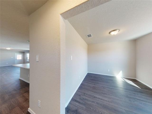 567 W Fountain St, Gardner, KS 66030 - unfurnished room featuring dark wood finished floors, baseboards, and a textured ceiling