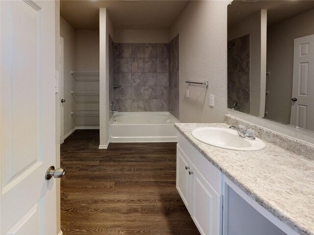 567 W Fountain St, Gardner, KS 66030 - full bath with vanity, wood finished floors, and bathing tub / shower combination