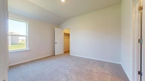 567 W Fountain St, Gardner, KS 66030 - unfurnished bedroom featuring carpet flooring, vaulted ceiling, baseboards, and a spacious closet
