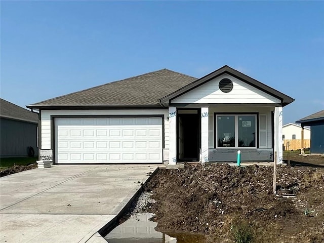 567 W Fountain St, Gardner, KS 66030 - view of front facade with driveway, an attached garage, and a shingled roof