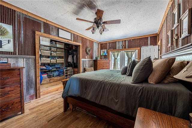 31425 Chance Ave, Warsaw, MO 65355 - bedroom with wooden walls, wood finished floors, a closet, and ceiling fan