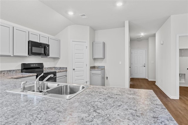 597 W Fountain St, Gardner, KS 66030 - kitchen featuring black appliances, light countertops, dark wood finished floors, a sink, and baseboards