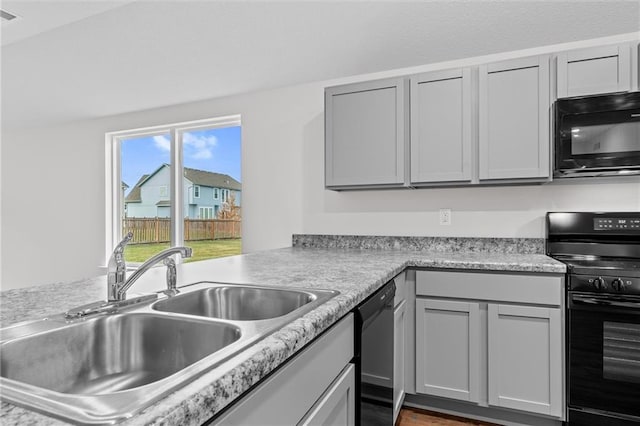 597 W Fountain St, Gardner, KS 66030 - kitchen with black appliances, a sink, light countertops, and gray cabinetry