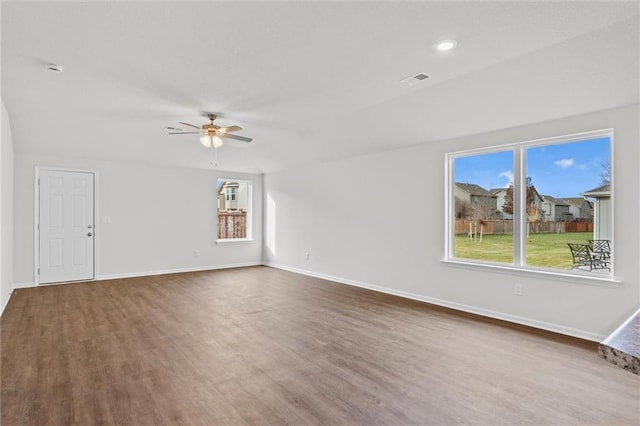 597 W Fountain St, Gardner, KS 66030 - unfurnished living room featuring wood finished floors, a ceiling fan, and plenty of natural light