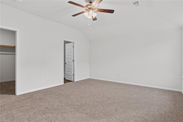 597 W Fountain St, Gardner, KS 66030 - unfurnished bedroom with vaulted ceiling, carpet flooring, a walk in closet, baseboards, and a closet