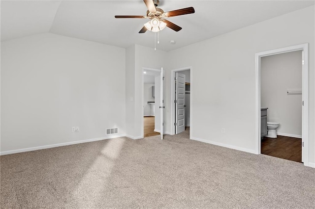 597 W Fountain St, Gardner, KS 66030 - unfurnished bedroom featuring carpet floors, a spacious closet, connected bathroom, baseboards, and vaulted ceiling