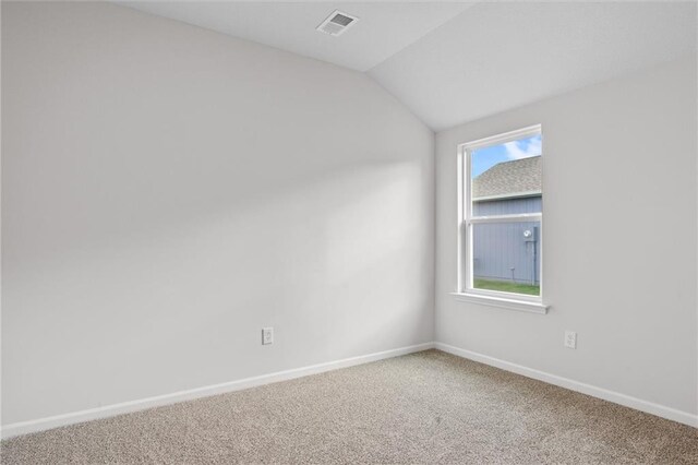 597 W Fountain St, Gardner, KS 66030 - spare room featuring carpet flooring, vaulted ceiling, and baseboards