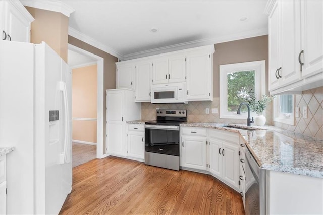 14155 W 147th Ter, Olathe, KS 66062 - kitchen featuring appliances with stainless steel finishes, a sink, white cabinetry, and crown molding
