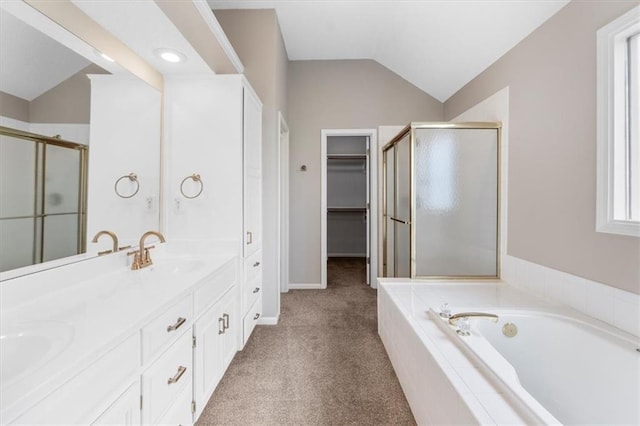 14155 W 147th Ter, Olathe, KS 66062 - bathroom with lofted ceiling, a stall shower, a garden tub, double vanity, and a spacious closet