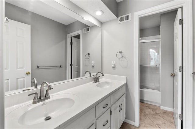 14155 W 147th Ter, Olathe, KS 66062 - full bathroom with double vanity, tile patterned floors, baseboards, and bath / shower combo with glass door