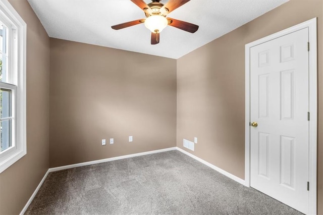 14155 W 147th Ter, Olathe, KS 66062 - carpeted spare room with plenty of natural light, a ceiling fan, and baseboards