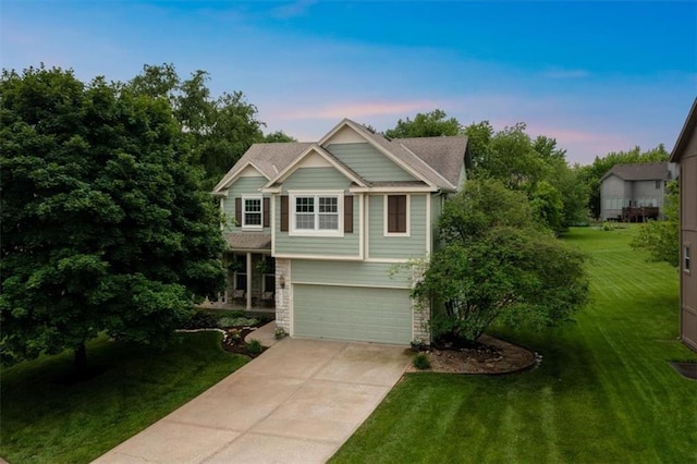 14155 W 147th Ter, Olathe, KS 66062 - view of front facade featuring stone siding, concrete driveway, an attached garage, and a lawn