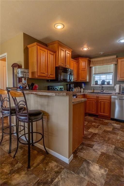 2943 NE Turkey Rd, Breckenridge, MO 64625 - kitchen featuring dishwasher, black microwave, a sink, dark stone finish floors, and a breakfast bar area