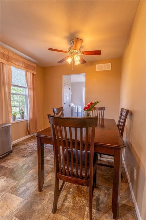 2943 NE Turkey Rd, Breckenridge, MO 64625 - dining space with baseboards, ceiling fan, and stone finish flooring