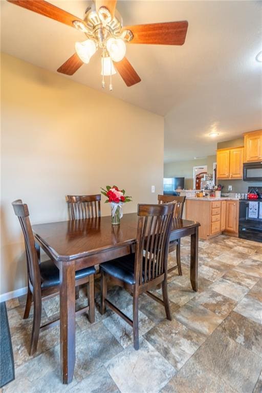 2943 NE Turkey Rd, Breckenridge, MO 64625 - dining space with a ceiling fan, light stone finish floors, and baseboards