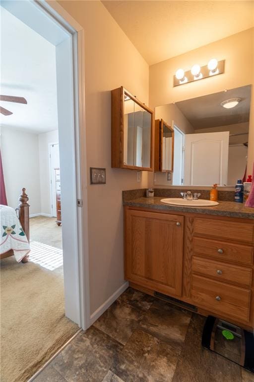 2943 NE Turkey Rd, Breckenridge, MO 64625 - bathroom featuring vanity, baseboards, and ceiling fan
