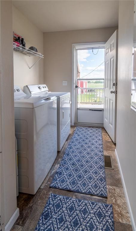 2943 NE Turkey Rd, Breckenridge, MO 64625 - laundry room with washing machine and dryer, healthy amount of natural light, and baseboards