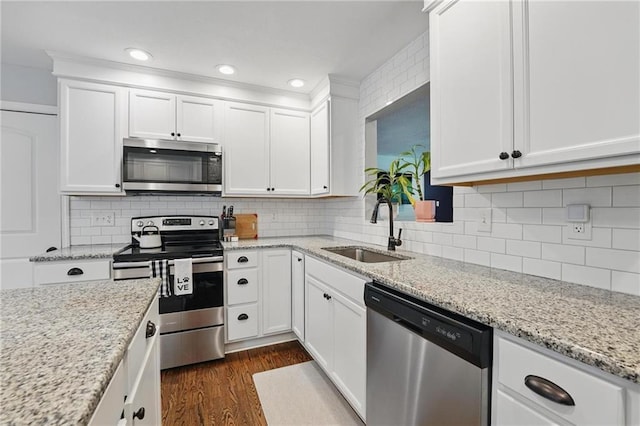 109 N 1st St, Blue Springs, MO 64014 - kitchen featuring stainless steel appliances, a sink, white cabinets, dark wood-style flooring, and recessed lighting