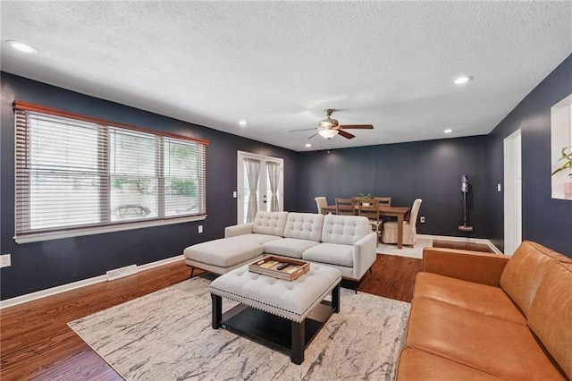 109 N 1st St, Blue Springs, MO 64014 - living room with ceiling fan, plenty of natural light, wood finished floors, a textured ceiling, and recessed lighting