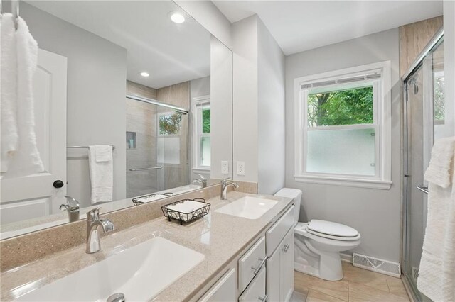 109 N 1st St, Blue Springs, MO 64014 - bathroom with a shower stall, double vanity, toilet, baseboards, and recessed lighting