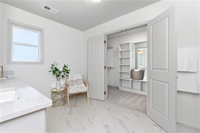 20786 Emerald St, Spring Hill, KS 66083 - bathroom featuring double vanity, marble finish flooring, and a spacious closet