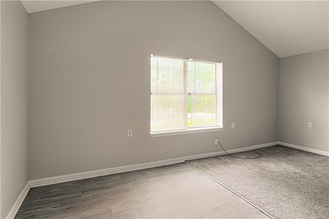 5926 Agnes Ave, Kansas City, MO 64130 - spare room with vaulted ceiling, baseboards, and wood finished floors