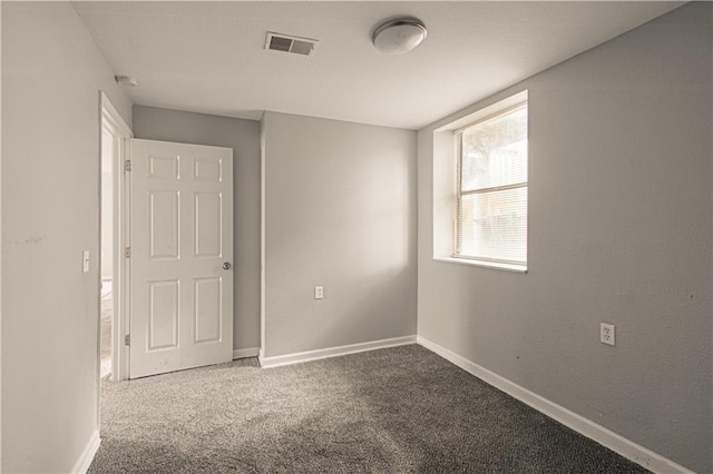 5926 Agnes Ave, Kansas City, MO 64130 - carpeted spare room featuring baseboards