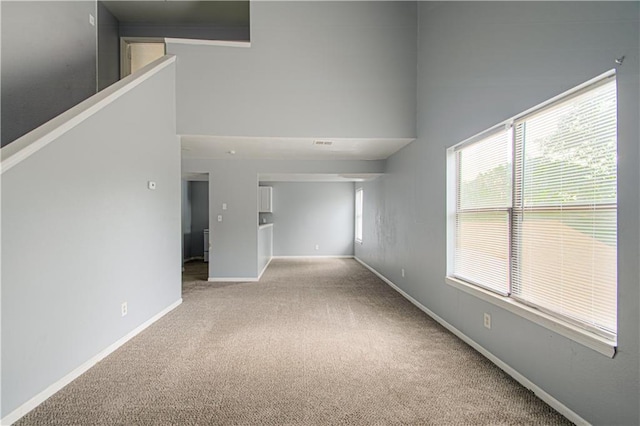 5926 Agnes Ave, Kansas City, MO 64130 - carpeted empty room with baseboards and plenty of natural light