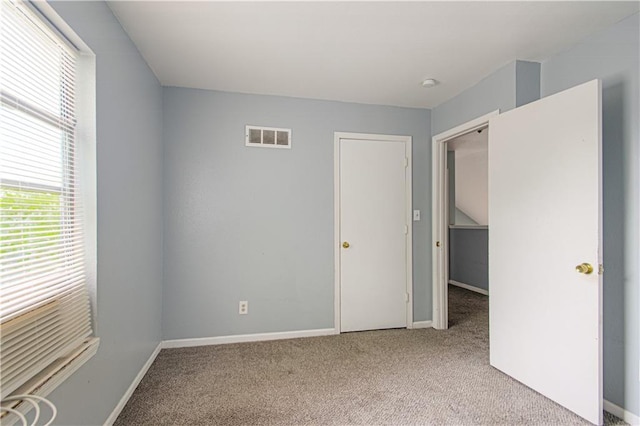 5926 Agnes Ave, Kansas City, MO 64130 - unfurnished bedroom featuring carpet, multiple windows, and baseboards