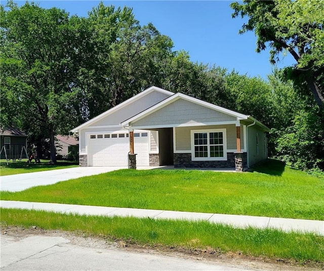 802 E N Main St, Richmond, MO 64085 - craftsman house with stone siding, a garage, concrete driveway, and a front yard