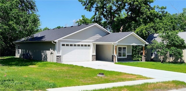 802 E N Main St, Richmond, MO 64085 - view of front of property with an attached garage, stone siding, a front yard, and concrete driveway