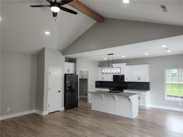 802 E N Main St, Richmond, MO 64085 - kitchen with black appliances, high vaulted ceiling, white cabinetry, a ceiling fan, and beamed ceiling