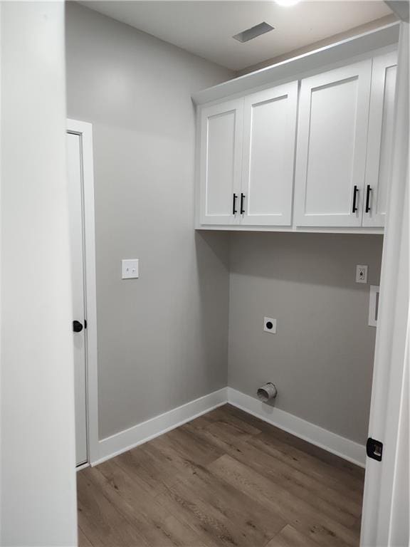802 E N Main St, Richmond, MO 64085 - washroom featuring electric dryer hookup, cabinet space, and dark wood-style floors