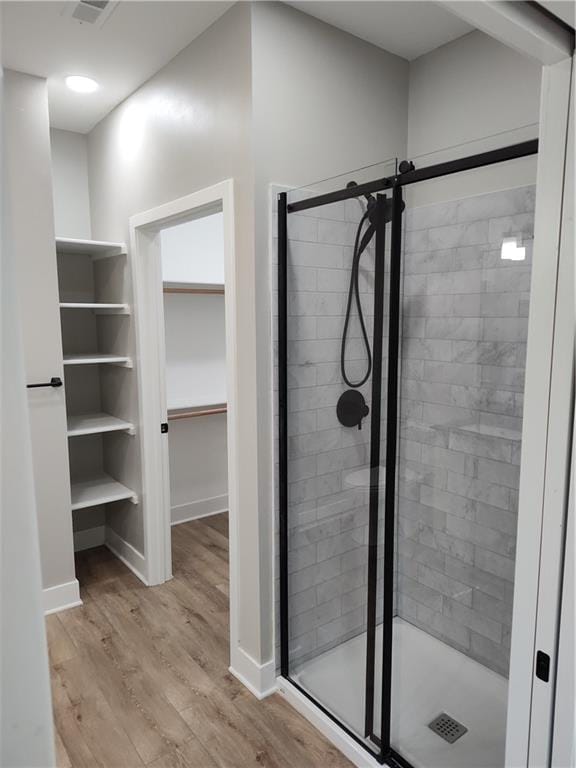 802 E N Main St, Richmond, MO 64085 - bathroom with a shower stall, wood finished floors, and a walk in closet
