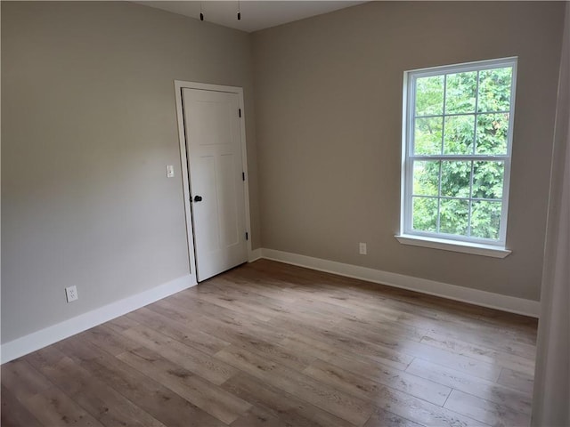 802 E N Main St, Richmond, MO 64085 - empty room with wood finished floors and plenty of natural light