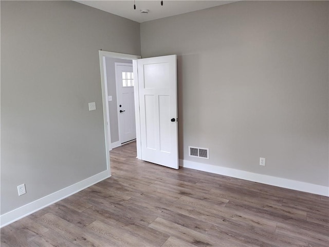 802 E N Main St, Richmond, MO 64085 - empty room with wood finished floors and baseboards
