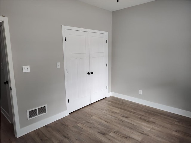802 E N Main St, Richmond, MO 64085 - unfurnished bedroom featuring wood finished floors and a closet