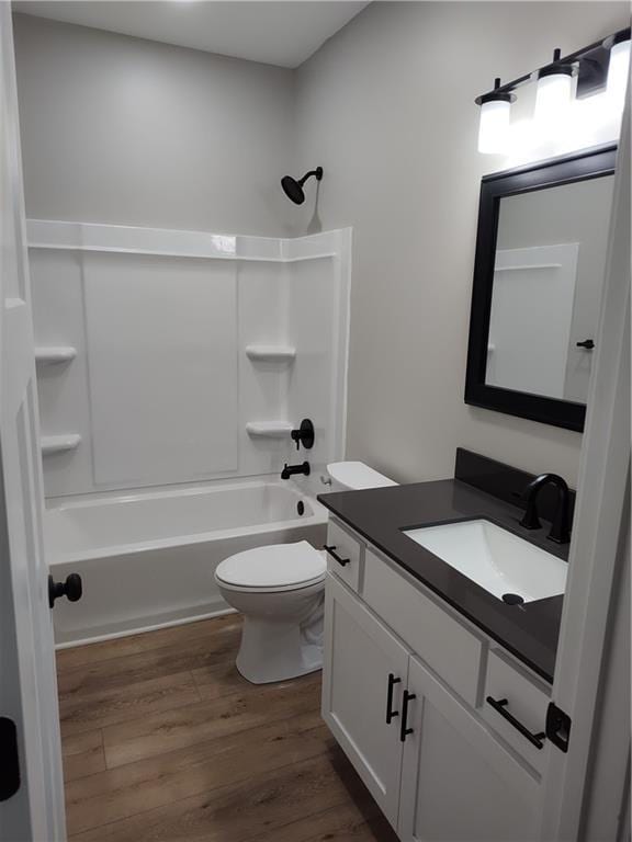 802 E N Main St, Richmond, MO 64085 - bathroom featuring vanity, wood finished floors, and bathing tub / shower combination