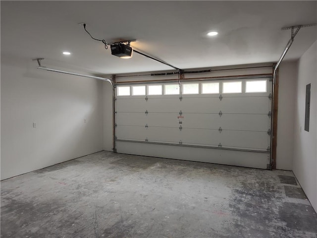 802 E N Main St, Richmond, MO 64085 - garage featuring a garage door opener and recessed lighting