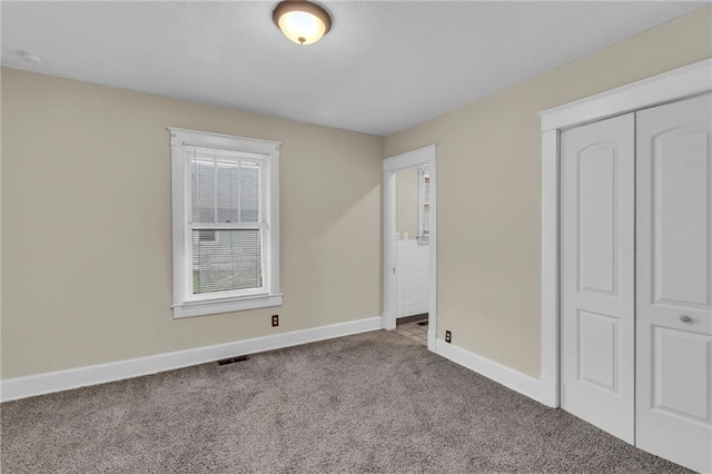 1403 S Sterling Ave, Independence, MO 64052 - unfurnished bedroom with carpet, baseboards, and a closet