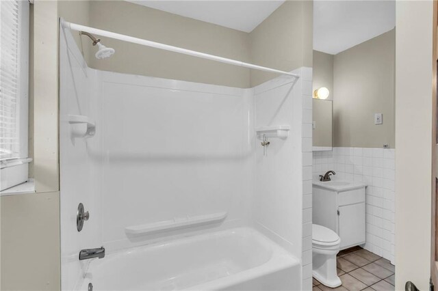 1403 S Sterling Ave, Independence, MO 64052 - bathroom featuring shower / washtub combination, tile patterned flooring, toilet, tile walls, and vanity