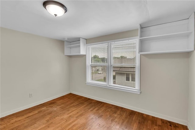 1403 S Sterling Ave, Independence, MO 64052 - spare room featuring baseboards and hardwood / wood-style floors