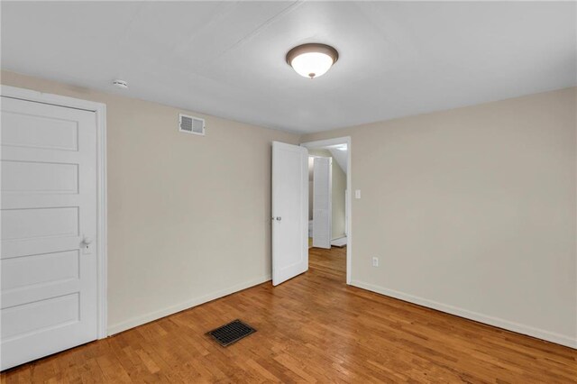 1403 S Sterling Ave, Independence, MO 64052 - empty room featuring baseboards, wood finished floors, and a smoke detector