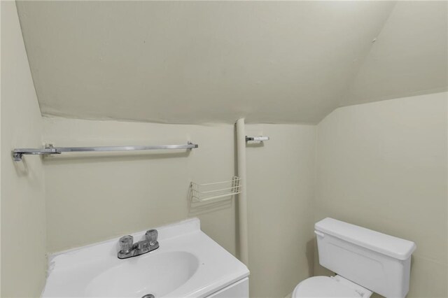 1403 S Sterling Ave, Independence, MO 64052 - half bath with vaulted ceiling, toilet, and vanity