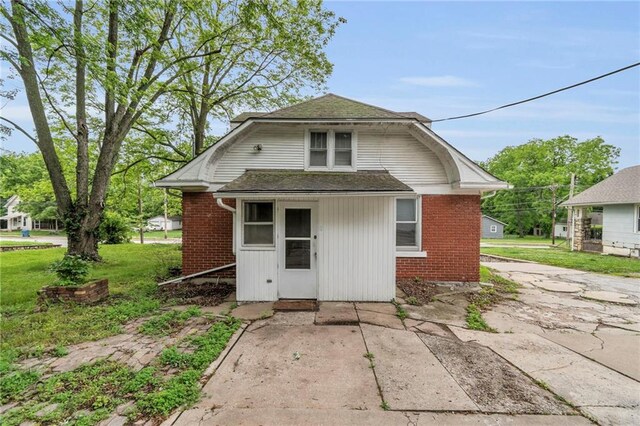 1403 S Sterling Ave, Independence, MO 64052 - back of house with brick siding and roof with shingles