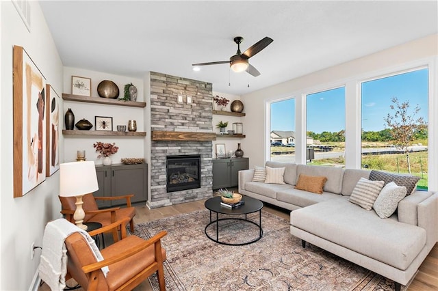 20714 Emerald St, Spring Hill, KS 66030 - living area featuring ceiling fan, wood finished floors, and a fireplace